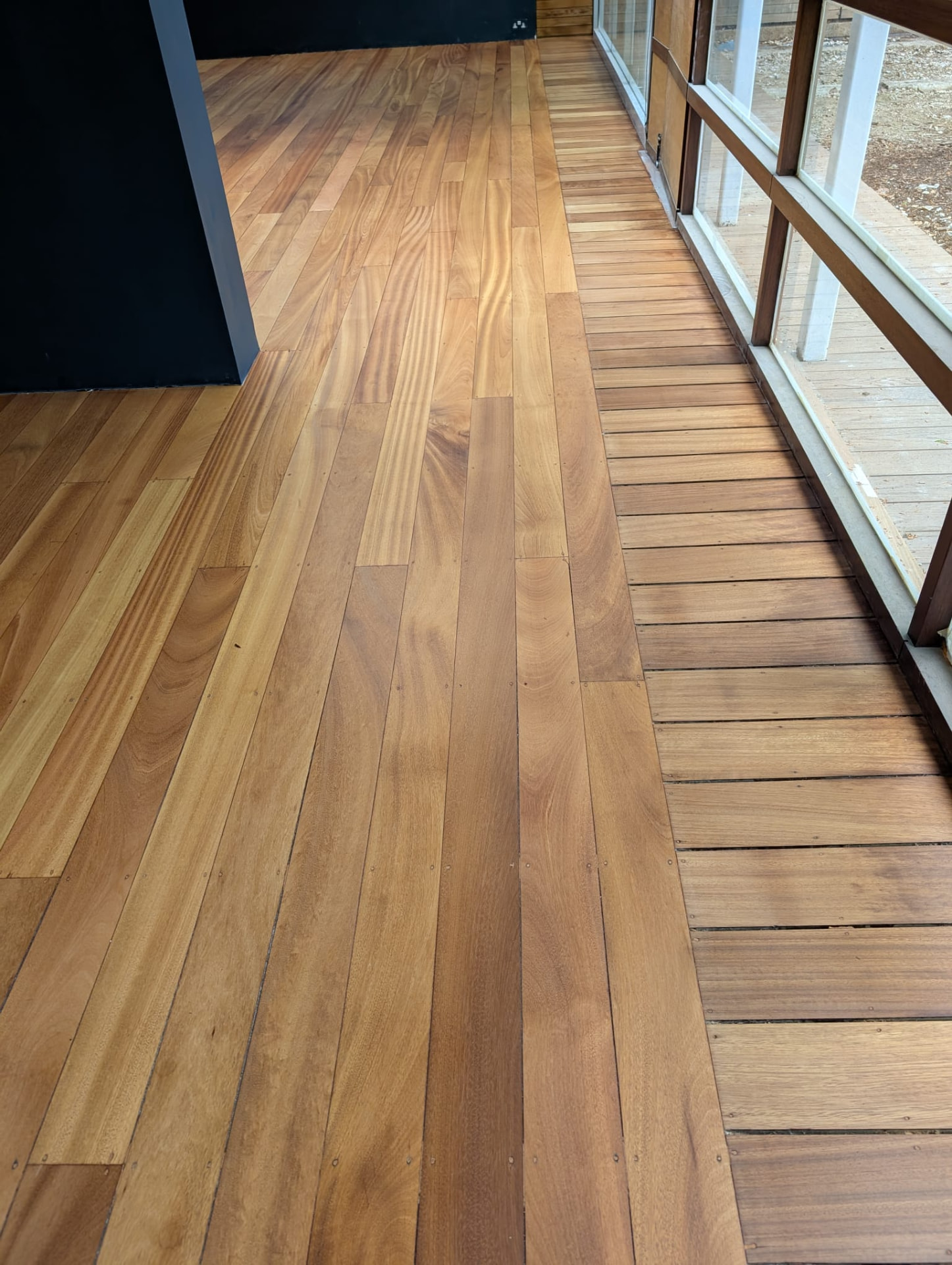 Newly installed wooden floor running alongside patio doors