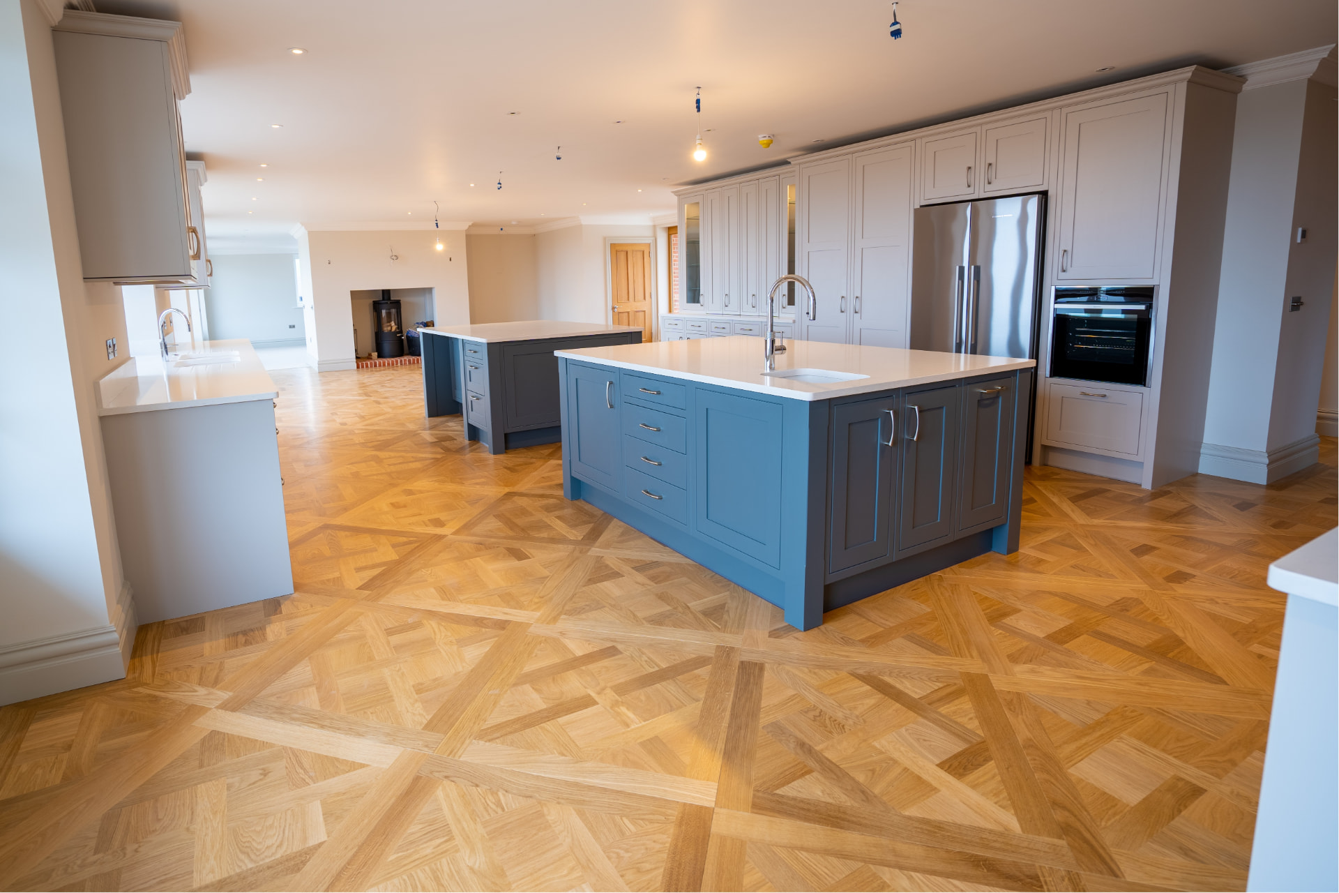 Newly installed herringbone parquet floor in a modern kitchen